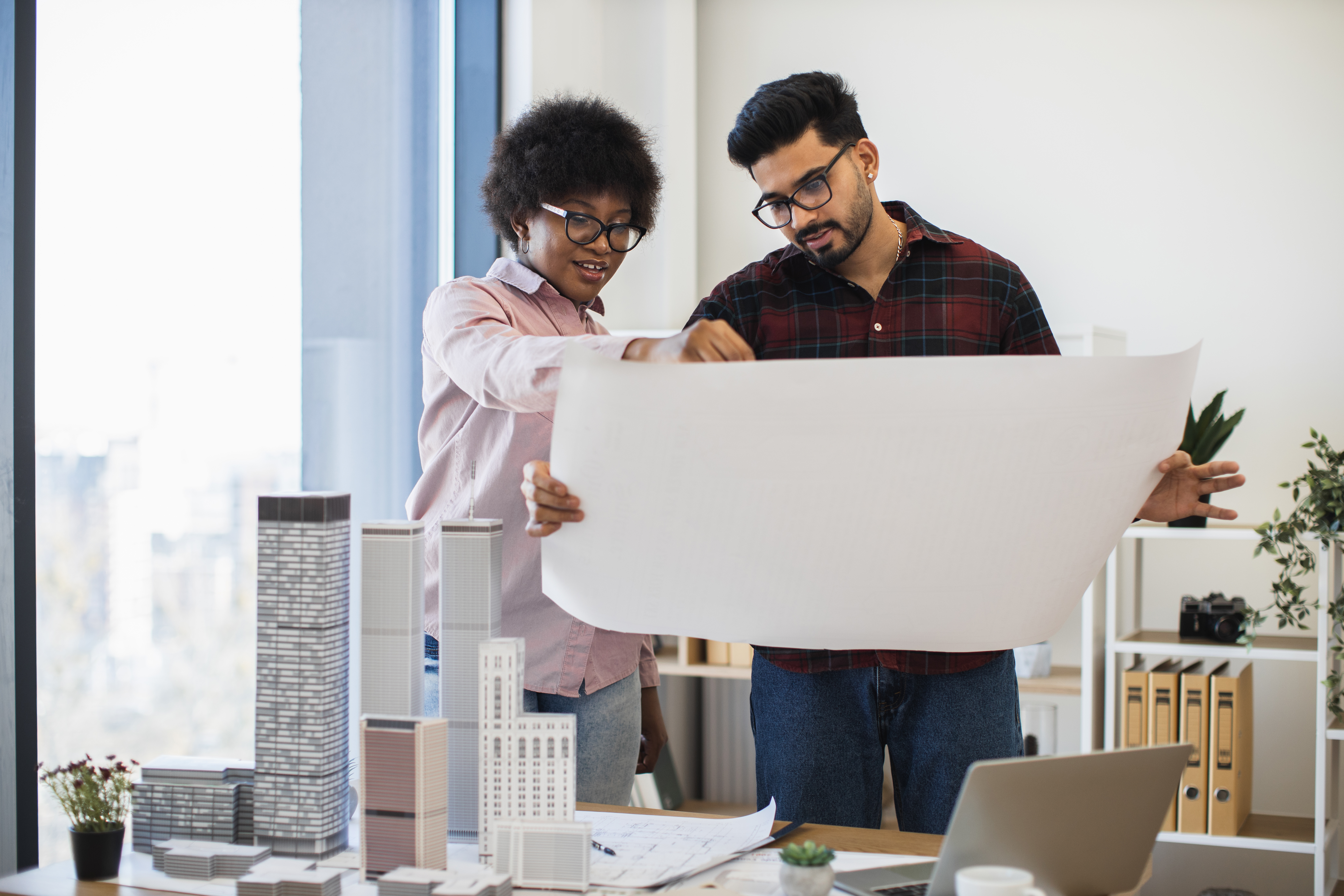 Urban planning team reviewing district blueprints